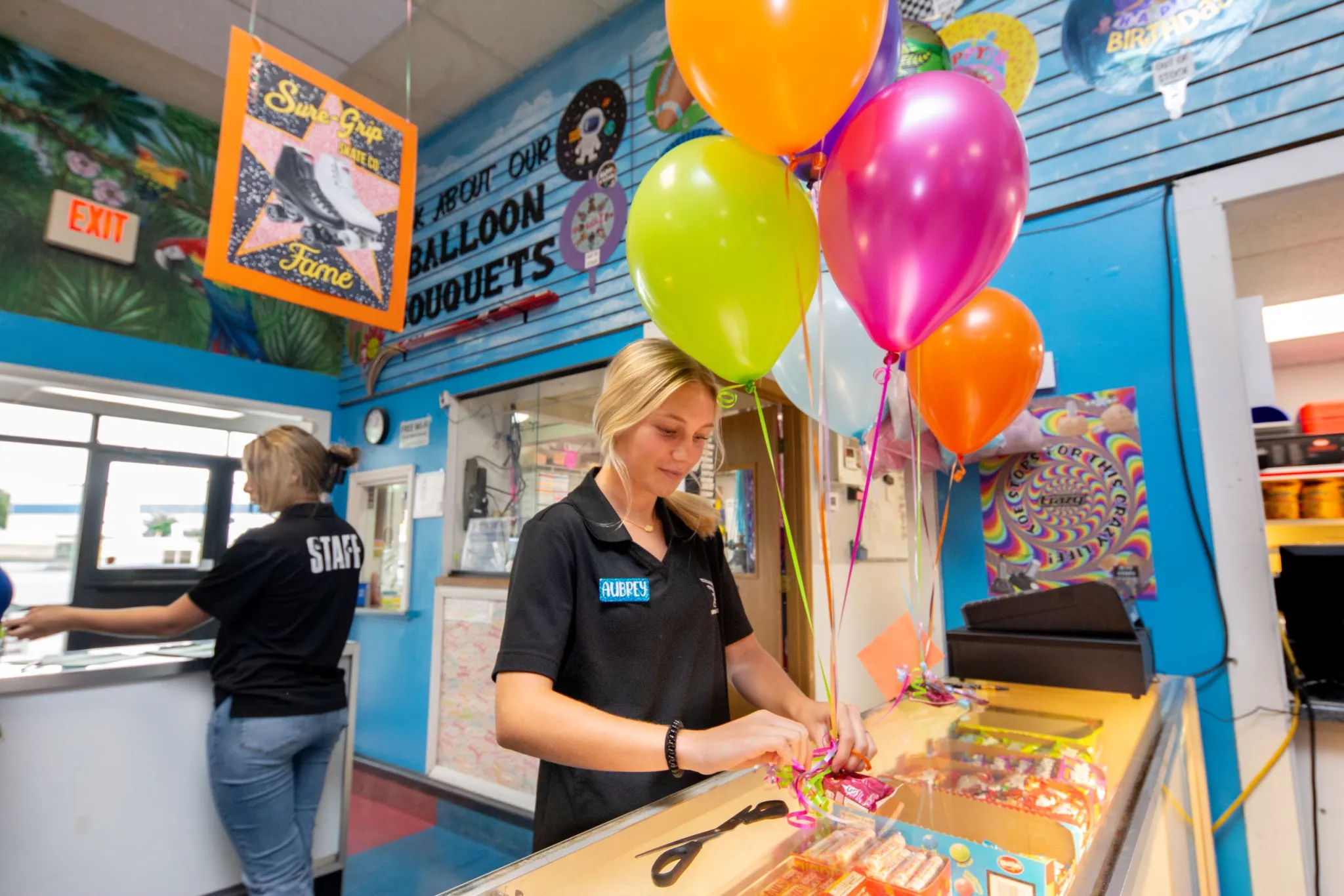 Balloon shop employee preparing bouquets