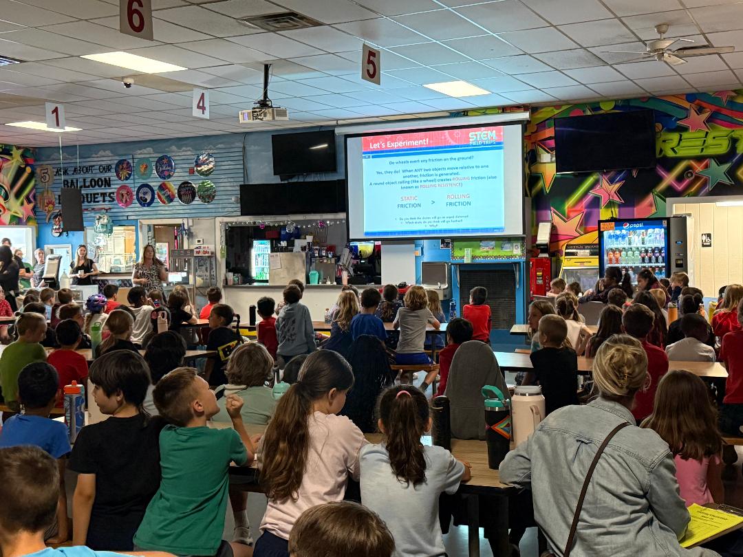 Elementary students watching presentation in cafeteria